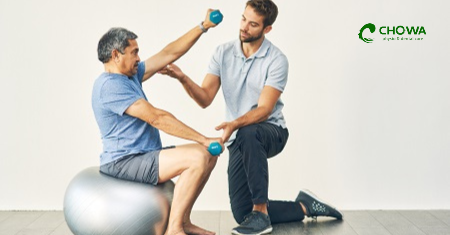 Senior arm rehab at Chowa physiotherapy clinic in Gulshan using dumbbells for strength training.
